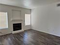 Bright living room with a fireplace, neutral walls, modern flooring and natural light from large windows at 1838 N Jones Blvd, Las Vegas, NV 89108