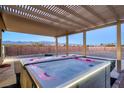 Relaxing hot tub under a pergola with a mountain view, perfect for outdoor enjoyment at 2051 Saginaw Ave, Pahrump, NV 89048