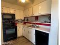 Galley kitchen that has white cabinets and modern appliances at 2064 Mesquite Ln # 304, Laughlin, NV 89029