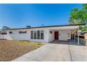 Charming single-story home with clean modern lines, a covered carport, and mature landscaping at 2105 Berkley Ave, Las Vegas, NV 89101