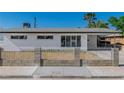 Curb appeal of this modern home is enhanced by the decorative white fence at 2105 Berkley Ave, Las Vegas, NV 89101