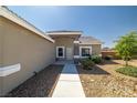 Inviting front entrance with desert landscaping and a charming, covered entryway at 230 S Weeping Willow Ct, Pahrump, NV 89048