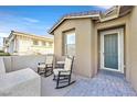Charming front porch with rocking chairs, creating a welcoming entrance to the home at 2383 Elmont Ave, North Las Vegas, NV 89086