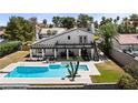Expansive backyard featuring a large pool, manicured lawn, patio seating, and serene outdoor oasis at 2425 Greens Ave, Henderson, NV 89014
