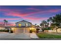 Charming two-story home with a well-manicured lawn, mature trees, and a spacious three-car garage at 2425 Greens Ave, Henderson, NV 89014