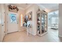 Welcoming foyer with tile flooring, white trim, and a decorative glass door at 2509 Libretto Ave, Henderson, NV 89052