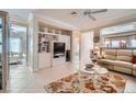 Open concept living room with tile floors, built-in shelving and media center at 2509 Libretto Ave, Henderson, NV 89052