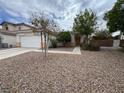 Charming single-Gathering home with a well-maintained front yard, gravel landscaping and a two-car garage at 2571 Swans Chance Ave, Henderson, NV 89052