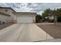A one story home featuring a two car garage and well manicured yard at 2571 Swans Chance Ave, Henderson, NV 89052