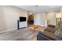 Open-concept living room featuring a comfortable gray sofa, TV, and dining area in the background at 2606 S Durango Dr # 260, Las Vegas, NV 89117