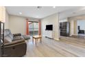 Bright living room featuring a sofa, wood-look floors, and access to a balcony at 2606 S Durango Dr # 260, Las Vegas, NV 89117