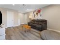 Inviting living room with a cozy gray sofa, world map tapestry, and neutral decor at 2606 S Durango Dr # 260, Las Vegas, NV 89117