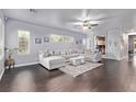 Spacious living room with large sectional sofa, dark wood floors and plenty of natural light at 3005 Dotted Wren Ave, North Las Vegas, NV 89084
