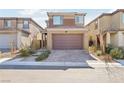 Two-story home featuring a brick paved driveway, neutral color palette, and well-maintained landscaping at 354 Spotted Dove St, Las Vegas, NV 89138