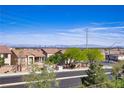 A view of a residential area with some mountain peaks and a distant cityscape at 4012 Owlshead Mountain St, Las Vegas, NV 89129