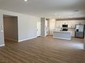 Bright open floor plan with wood-style flooring connecting the living space to the modern kitchen at 4388 Cave Lake Ave, North Las Vegas, NV 89032
