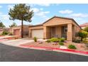 Charming single-story home featuring a two-car garage and desert landscaping at 601 Bear Grass St, Las Vegas, NV 89144