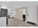 Bright kitchen with white cabinets, stainless steel appliances, and new light gray laminate flooring at 608 W Mcdermit St, Las Vegas, NV 89107