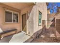 Home entryway with a bench, landscaped front yard, outdoor lighting and secure gated access to backyard at 632 Twilight Blue Ave, North Las Vegas, NV 89032