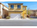 Two-story home with a two-car garage, desert landscaping, and a charming entryway at 648 Sumatra Pl, Henderson, NV 89011