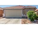 Close up of the garage door and front facade of this single-story home with xeriscaping at 6489 Coldwater Bay Dr, Las Vegas, NV 89122