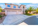 Beautiful two-story home with a three-car garage and well-manicured landscaping at 695 Orbiter Ln, Las Vegas, NV 89148