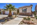 Charming single-story home with desert landscaping featuring cacti and a small tree at 7489 Crystal Clear Ave, Las Vegas, NV 89113
