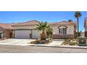 Charming single-story home with desert landscaping, two-car garage, and stone accents at 7489 Crystal Clear Ave, Las Vegas, NV 89113