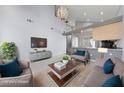 Bright living room with high ceilings, modern furnishings, and an open concept kitchen at 7589 Grassy Bank St, Las Vegas, NV 89139