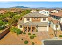An aerial view of a home showcasing the rooftop with a stunning desert mountain view in the background at 7931 Campers Village Ave, Las Vegas, NV 89178