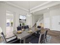 Open dining room boasts a large table, modern light fixture, and easy access to other living spaces at 7931 Campers Village Ave, Las Vegas, NV 89178