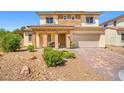 Charming two-story home featuring a brick-accented facade, covered porch, and a manicured front yard at 7931 Campers Village Ave, Las Vegas, NV 89178