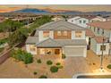 Stunning aerial view of a two-story home with a well-maintained landscape and a brick-paved driveway at 7931 Campers Village Ave, Las Vegas, NV 89178
