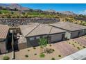 An aerial view showcasing modern homes with neatly landscaped yards and mountain views at 897 Woodburn Ln, Las Vegas, NV 89138