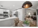 Modern kitchen featuring stainless steel appliances, white cabinets, and a breakfast nook at 9540 Eagle Valley Dr, Las Vegas, NV 89134