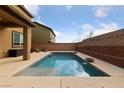 Inviting backyard featuring a sparkling swimming pool with lounge chairs, and a brick privacy wall at 10373 Northern Hills Ave, Las Vegas, NV 89166