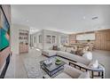 Contemporary living area flows into kitchen, featuring sleek finishes and abundant natural light at 10528 Garden Light Dr, Las Vegas, NV 89135