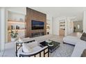 Open-concept living area featuring a fireplace, stylish seating, and views of other rooms at 10528 Garden Light Dr, Las Vegas, NV 89135