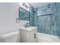 Stylish bathroom with sleek vanity, modern fixtures, and a bathtub featuring blue tiling at 1109 E Tonopah Ave, North Las Vegas, NV 89030