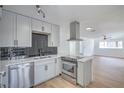 Modern kitchen featuring stainless steel appliances, sleek cabinets, and an island with a cooktop at 1109 E Tonopah Ave, North Las Vegas, NV 89030