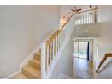 Bright staircase features tile steps, white risers, and wood handrail, bathed in natural light at 11833 Amistoso Ln, Las Vegas, NV 89138