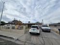 Street view of a single story home with a front yard, driveway and wrought iron fence at 1338 Smoke Tree Ave, Las Vegas, NV 89108