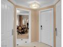 View of a hallway leading into a well-appointed living space, with neutral walls and white doors at 135 E Harmon Ave # 3620, Las Vegas, NV 89109