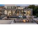 Expansive outdoor living space with multiple pools, hot tub, fireplace and mountain views at 1491 Reims Dr, Henderson, NV 89012