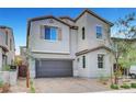 Charming two-story home with tan paint, a tile roof, desert landscaping, and a convenient two-car garage at 15 Santo Mio Ct, Henderson, NV 89011