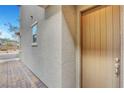 Inviting home exterior featuring textured stucco, a modern door, and manicured landscaping at 15 Santo Mio Ct, Henderson, NV 89011