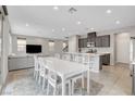 Open-concept living space with a large kitchen island, a dining table for eight, and a comfortable seating area at 15 Santo Mio Ct, Henderson, NV 89011