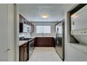 Bright kitchen boasts stainless steel appliances, wooden cabinets, and white countertops at 1550 Jamielinn Ln # 102, Las Vegas, NV 89110