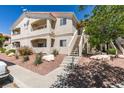A beautiful condo building featuring balconies, desert landscaping, and a tile roof at 1881 W Alexander Rd # 2079, North Las Vegas, NV 89032