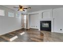 Bright living room featuring a fireplace, wood floors, and neutral wall paint at 189 Regal Sunset Ave, Henderson, NV 89002